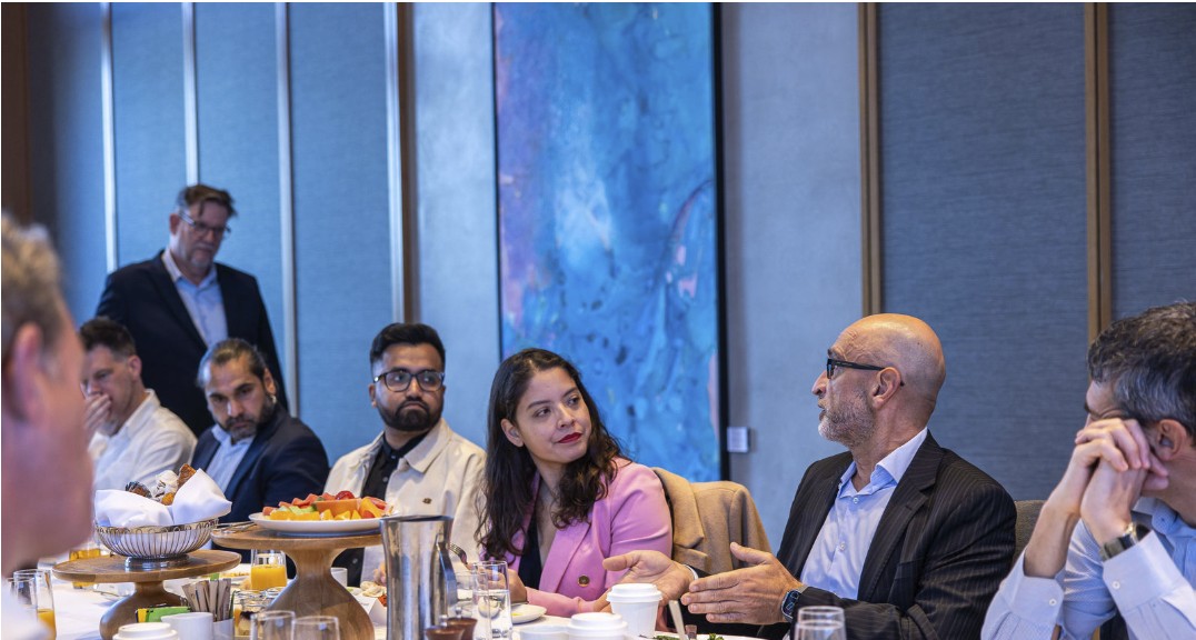 Executive breakfast attendees in conversation